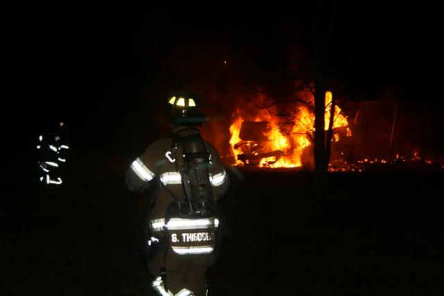 Cheshire Fire Fighters Scott Thibodeau (R) and Nick Kehoss (L) prepare to attack this well-involved vehicle fire on Interstate 691 during the early morning hours of March 27, 2010.